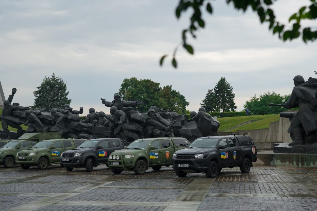 Donated vehicles from the 44th NAFO convoy at the Mother Ukraine monument in Kyiv